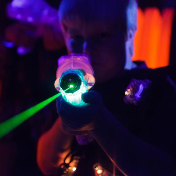 Close Up Shot of Boy Holding Laser Zapper in Laser Tag Arena